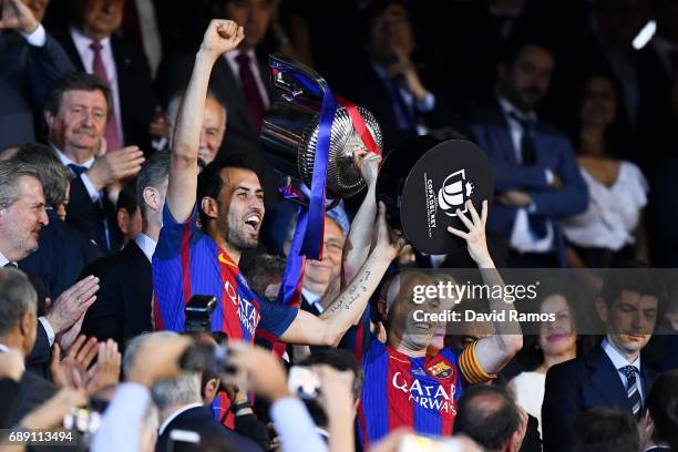 Sergio Busquets and Andres Iniesta of FC Barcelona hold up the trophy after winning the Copa Del Rey Final between FC Barcelona and Deportivo Alaves...