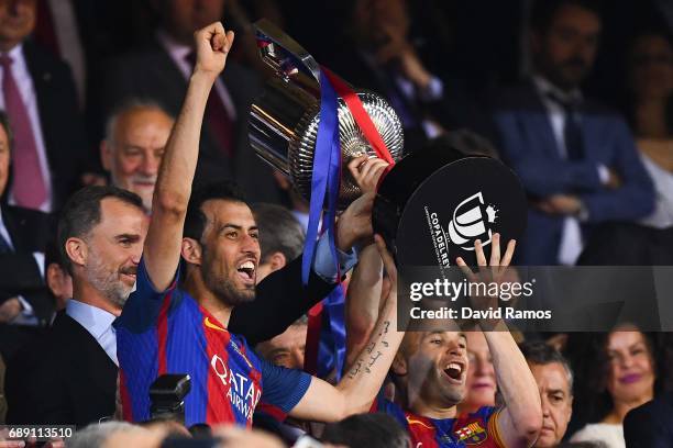 Sergio Busquets and Andres Iniesta of FC Barcelona hold up the trophy after winning the Copa Del Rey Final between FC Barcelona and Deportivo Alaves...