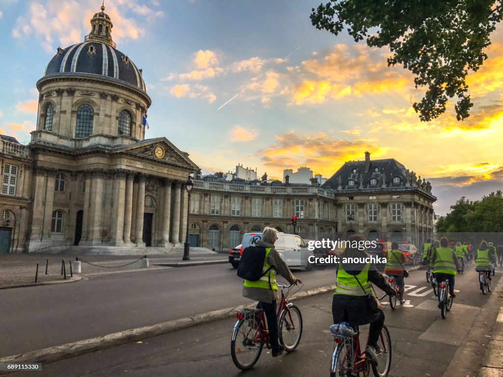People cycling along Seine river in Paris, France