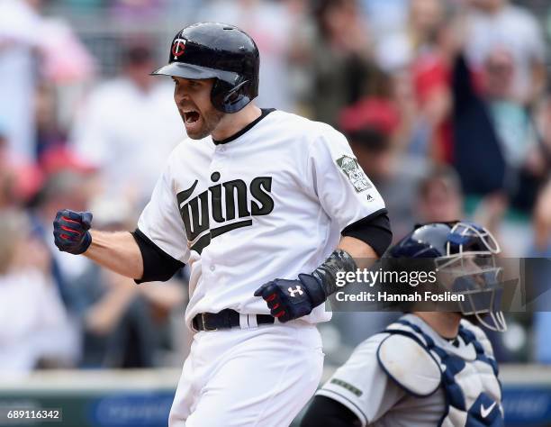 Brian Dozier of the Minnesota Twins celebrates hitting a two-run home run as Derek Norris of the Tampa Bay Rays looks on during the eighth inning of...