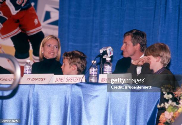 Wayne Gretzky of the New York Rangers with his wife and sons, Janet, Ty and Trevor, talks to the media during the press conference for Gretzky's...