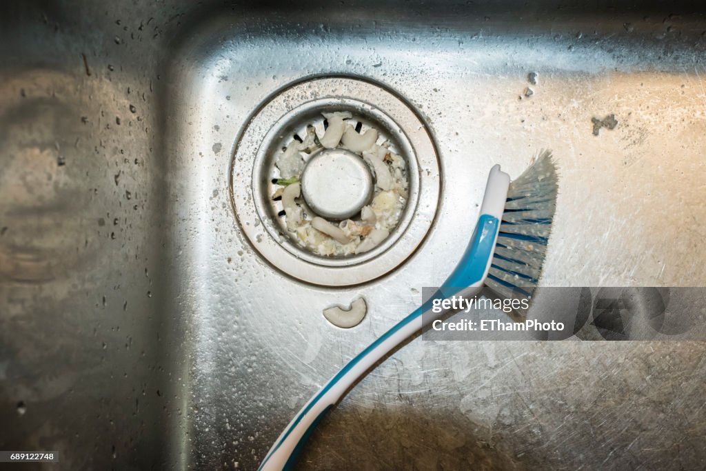 Dirty dishwashing brush in the sink