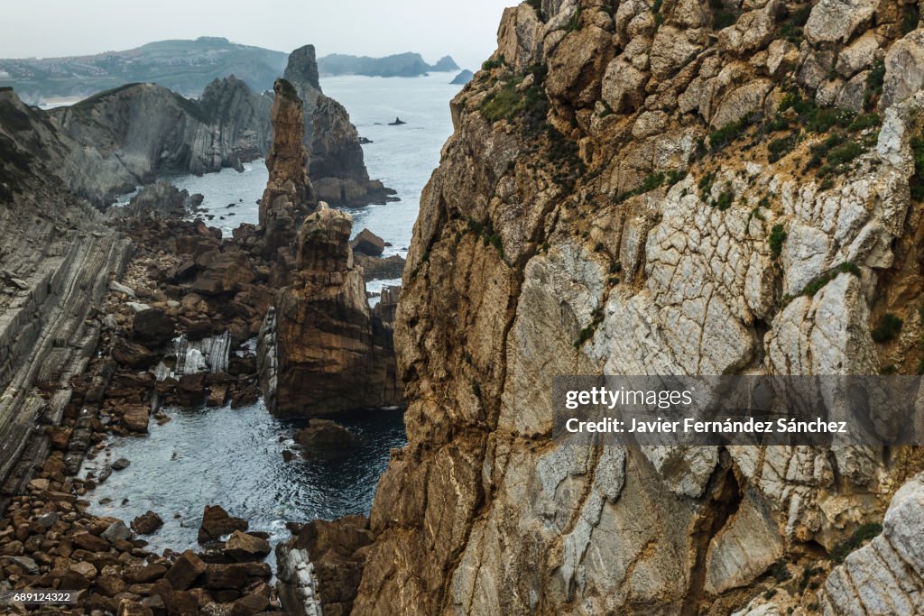 Aerial view of the steep coast of the cliffs in Liencres, Cantabria, Spain.
