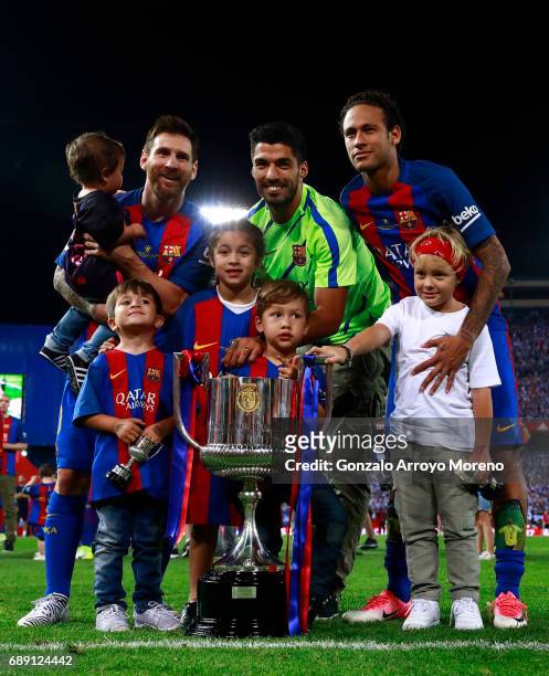 Lionel Messi Luis Suarez and Neymar JR. Of FC Barcelona and their children pose for a picture with the King's Cup after winning the Copa Del Rey...