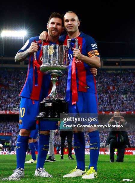 Lionel Messi and captain Andres Iniesta of FC Barcelona pose for a picture with the King's Cup after winning the Copa Del Rey Final between FC...