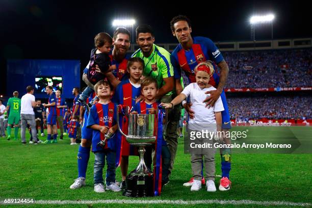Lionel Messi Luis Suarez and Neymar JR. Of FC Barcelona and their children pose for a picture with the King's Cup after winning the Copa Del Rey...