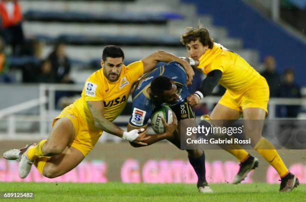 Tevita Kuridrani of Brumbies is tackled by Jeronimo de la Fuente and Bautista Ezcurra of Jaguares during a match between Jaguares and Brumbies as...