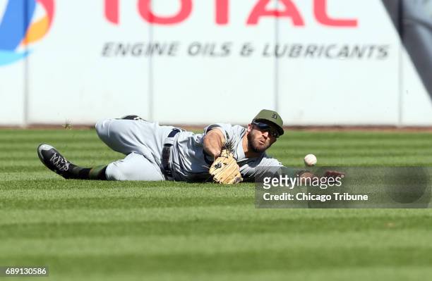 Detroit Tigers center fielder Tyler Collins misses a single by the Chicago White Sox's Jose Abreu in the eighth inning of the first game of a...