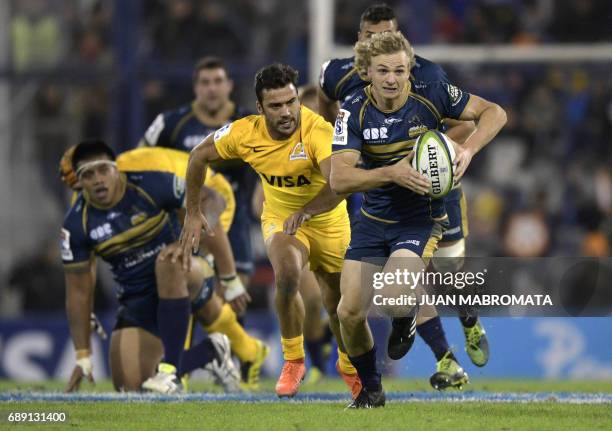 Australia's Brumbies scrum-half Joe Powell is chased by Argentina's Jaguares scrum-half Martin Landajo during their Super Rugby match at Jose...