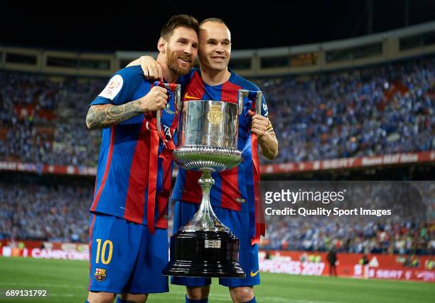 Andres Iniesta and Lionel Messi of FC Barcelona celebrate with the trophy after winning the Copa Del Rey Final match between FC Barcelona and...