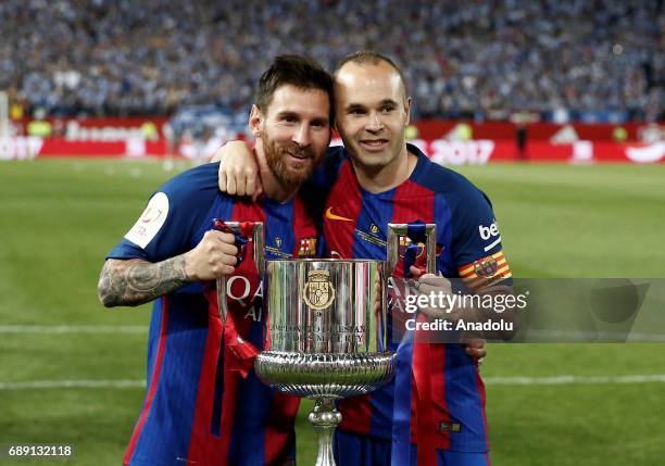 Lionel Messi and Andres Iniesta of Barcelona celebrate with the trophy after the Copa Del Rey Final between FC Barcelona and Deportivo Alaves at...