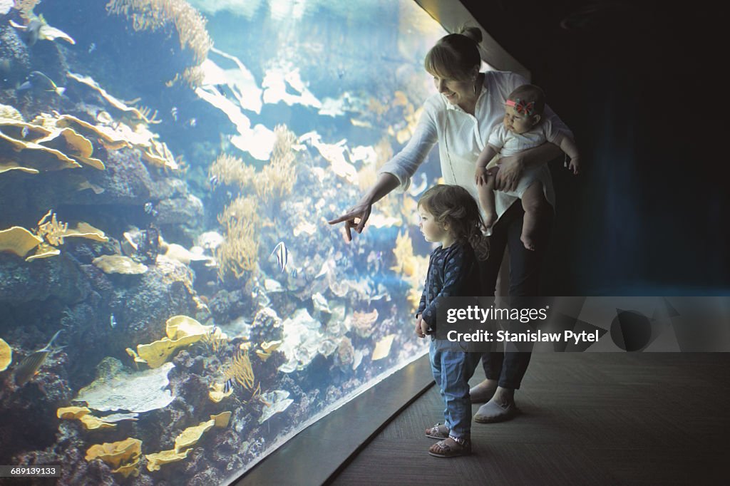 Mother with two daughters at aquarium