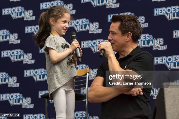 John Barrowman talks to a young fan, while taking questions from the audience, on day one of the Heroes and Villians Convention at Olympia London on...