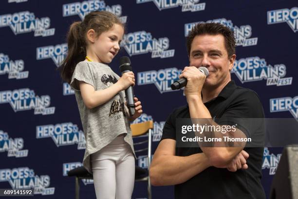 John Barrowman talks to a young fan, while taking questions from the audience, on day one of the Heroes and Villians Convention at Olympia London on...