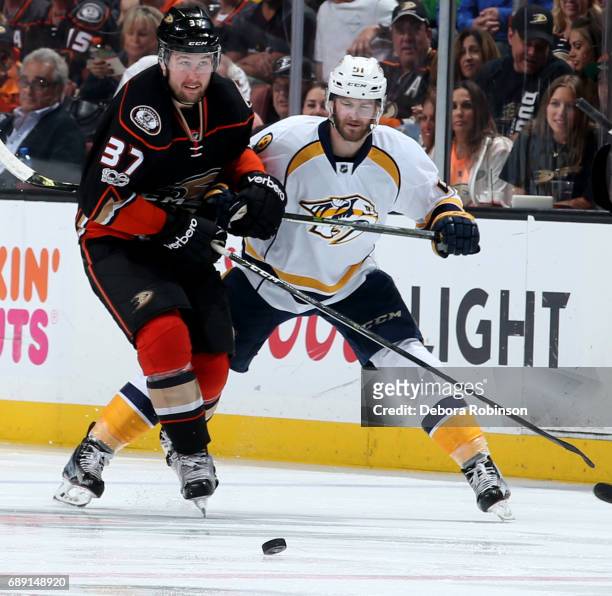 Nick Ritchie of the Anaheim Ducks battles for the puck against Austin Watson of the Nashville Predators in Game Five of the Western Conference Final...