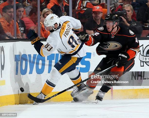 Josh Manson of the Anaheim Ducks battles for the puck against Vernon Fiddler of the Nashville Predators in Game Five of the Western Conference Final...