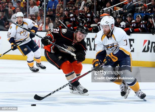 Yannick Weber of the Nashville Predators handles the puck against Chris Wagner of the Anaheim Ducks in Game Five of the Western Conference Final...