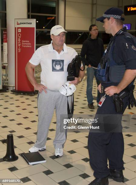 Member of 'Anonymous' speaks to the police while waiting for the arrival for Schapelle Corby at Brisbane International Airport on May 28, 2017 in...