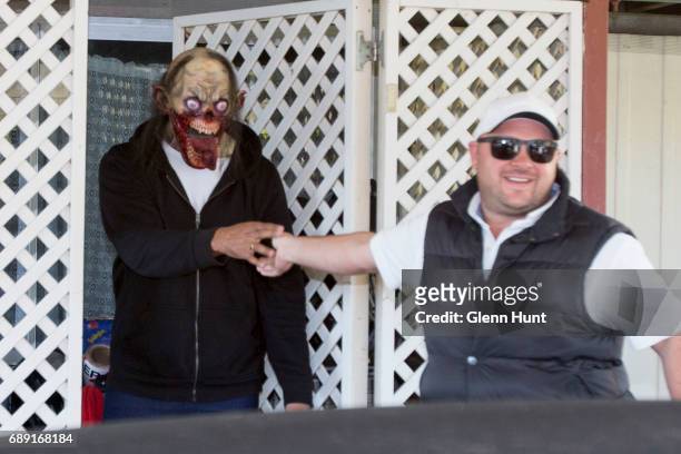 Corby security guard says goodbye to a masked occupant of Schappelle Corby's mother's house in Loganlea on May 28, 2017 in Brisbane, Australia....