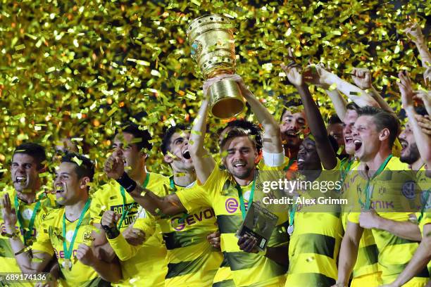 Team captain Marcel Schmelzer of Dortmund lifts the trophy after winning the DFB Cup Final between Eintracht Frankfurt and Borussia Dortmund at...