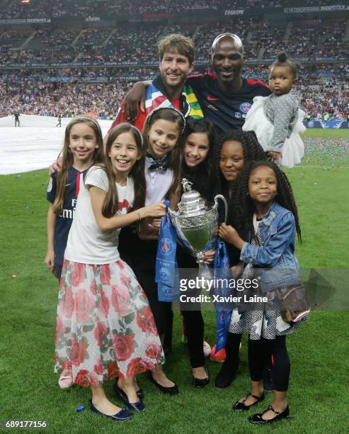 Maxwell and Zoumana Camara of Paris Saint-Germain celebrate the cup with their children after the French Cup Final match between Paris Saint-Germain...