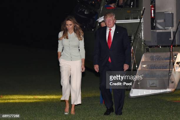 President Donald Trump and First Lady Melania Trump return to the White House on May 27, 2017 in Washington, DC. Trump is returning from his first...