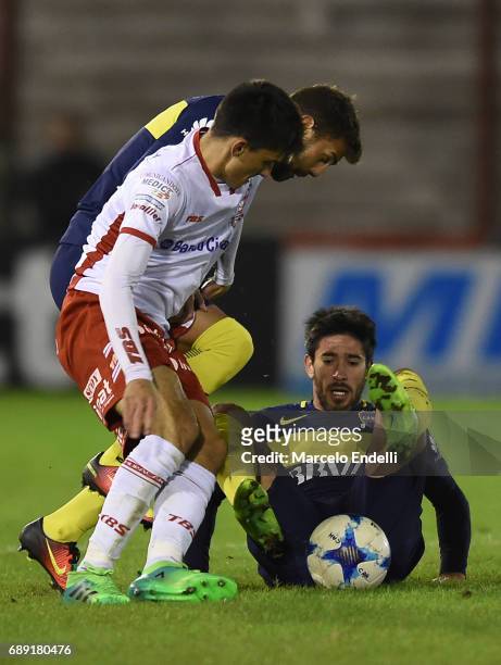 Ignacio Pussetto of Huracan fights for ball with Pablo Perez of Boca Juniors during a match between Huracan and Boca Juniors as part of Torneo...