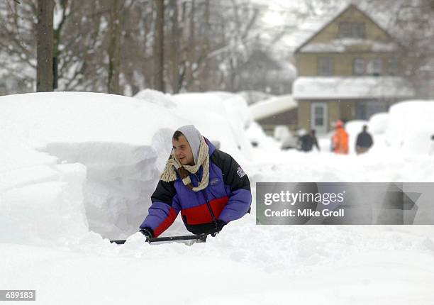 Mike Rodriguez digs his car out of a snow pile December 27, 2001 in Buffalo, NY. Buffalo has been pounded by a lake effect snow storm resulting in...