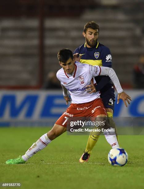 Ignacio Pussetto of Huracan fights for ball with Gino Peruzzi of Boca Juniors during a match between Huracan and Boca Juniors as part of Torneo...