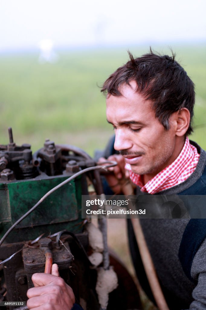 Young men repairing engine