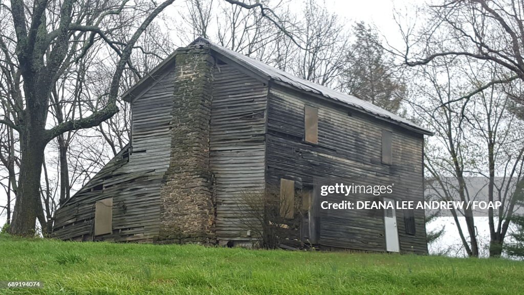 Old abandoned house on the grassy land