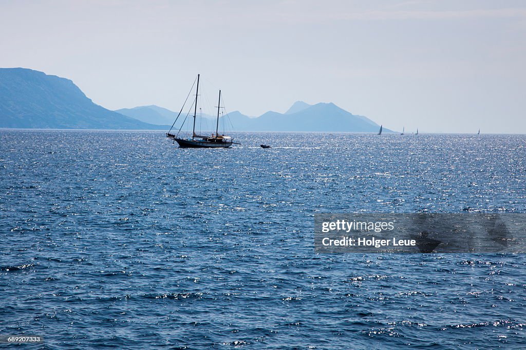 Sailboat in Adriatic Sea with mountain backdrop