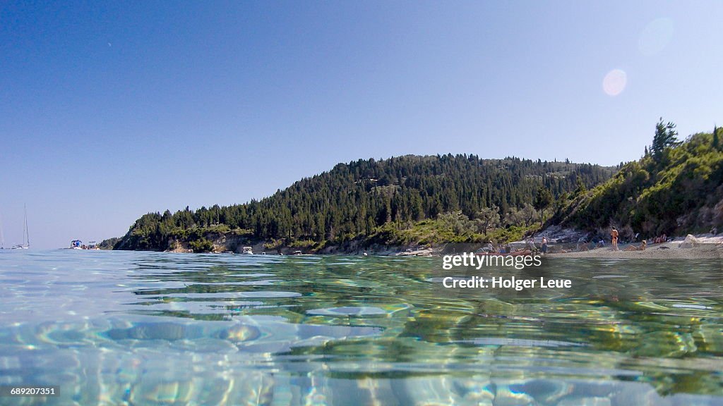 Clear waters, people on beach and coastline