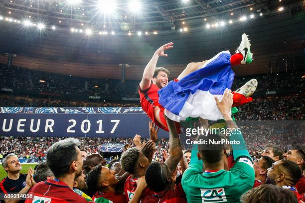 Paris Saint-Germain's Brazilian defender Maxwell is lifted by teammates after winning the French Cup final football match between Paris Saint-Germain...