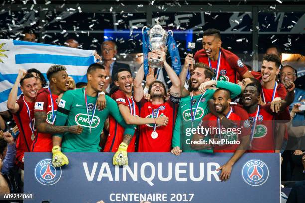 Paris Saint-Germain's Brazilian defender Maxwell holds the trophy as he celebrates winning the French Cup final football match between Paris...