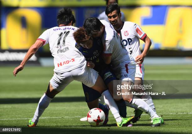 Yusuke Goto of Oita Trinita competes for the ball against Park Hyung Jin , Shohei Takeda and Kazuhito Watanabe of Fagiano Okayama during the J.League...
