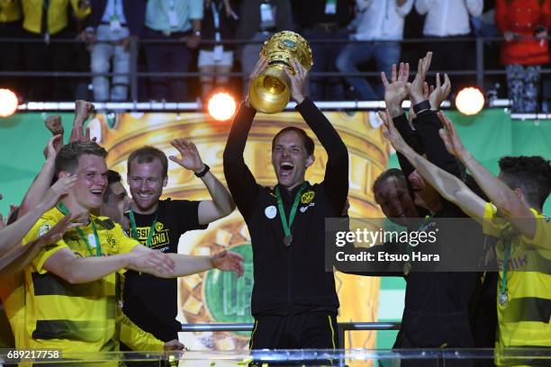 Head coach Thomas Tuchel of Borussia Dortmund lifts the trophy at the medal ceremony after the DFB Cup Final match between Eintracht Frankfurt and...