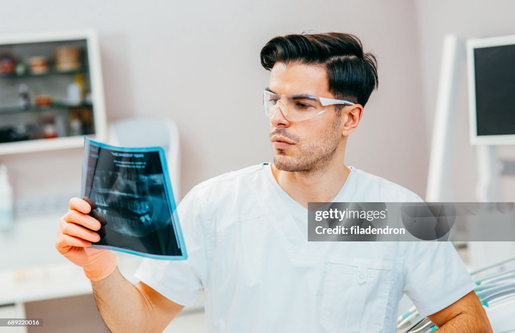 Dentist looking at an x-ray