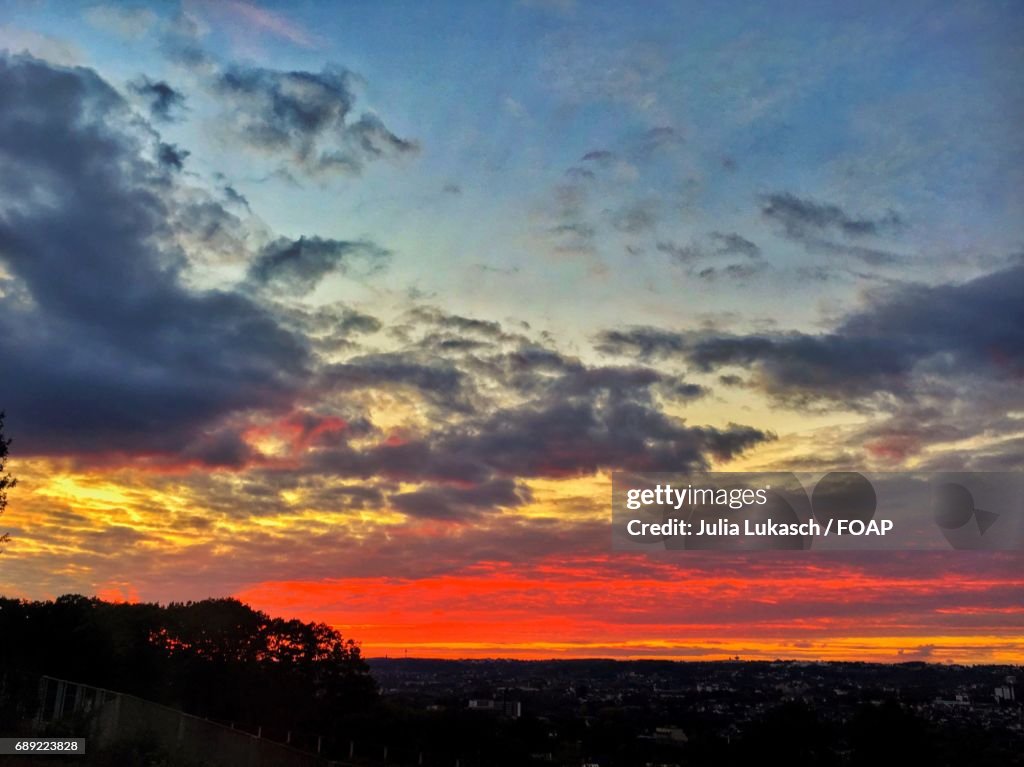 Dramatic sky over town at dusk