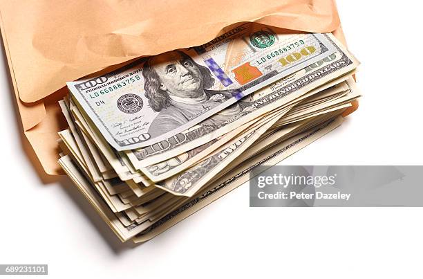 us dollars in brown envelope - brown envelope stock pictures, royalty-free photos & images