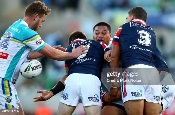 Joseph Leilua of the Raiders offloads during the round 12 NRL match between the Canberra Raiders and the Sydney Roostrers at GIO Stadium on May 28,...