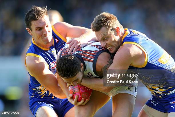 Daniel Lloyd of the Giants gets tackled by Sam Butler and Sam Mitchell of the Eagles during the round 10 AFL match between the West Coast Eagles and...