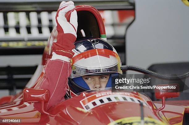 Austrian Formula One racing driver Gerhard Berger pictured in the driver's seat of the Scuderia Ferrari 412T1 V12 prior to competing to finish in...