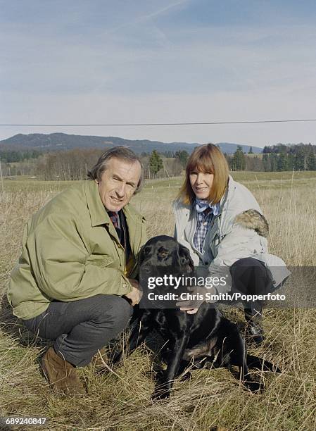 British former three time Formula One world champion racing driver, Jackie Stewart pictured with his wife Helen Stewart and pet Labrador dog in the...