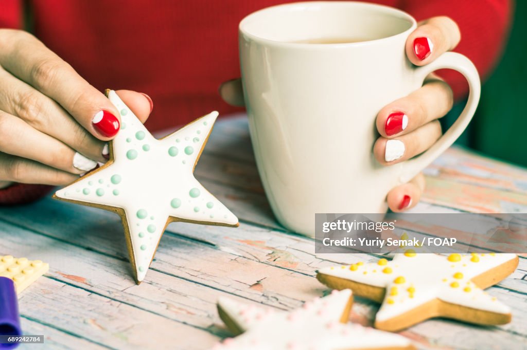 Women holding star shape cookie