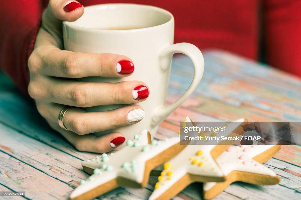 Women hand with cup of tea