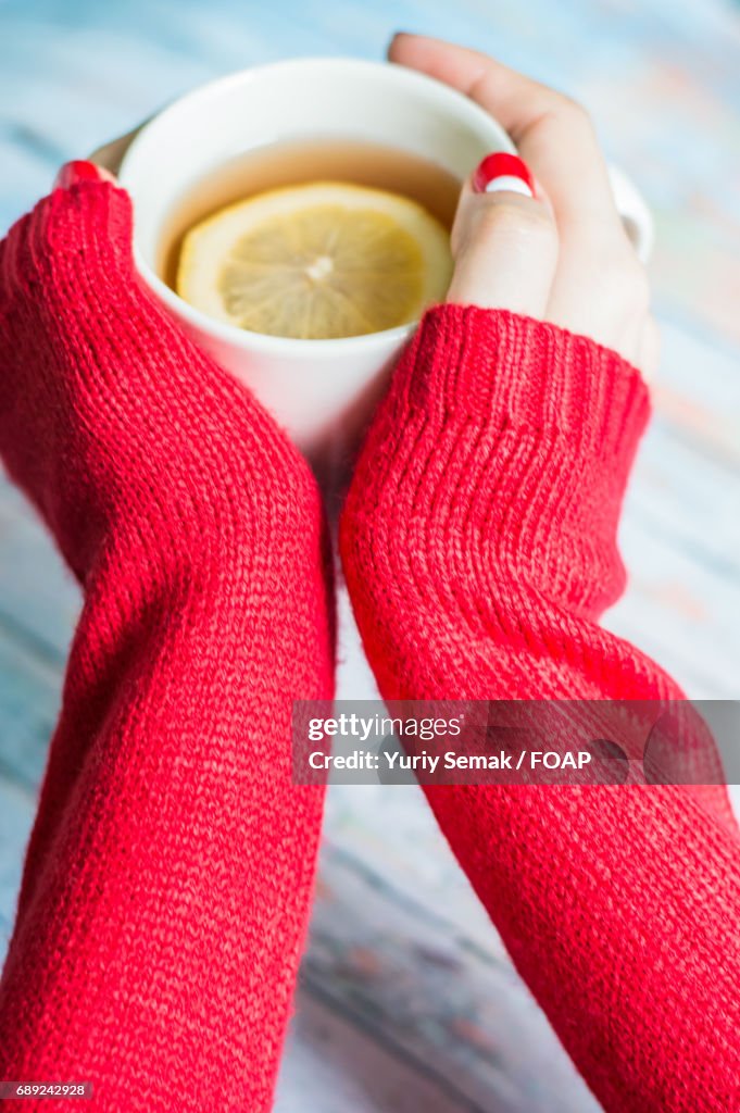 Woman hand with cup of tea