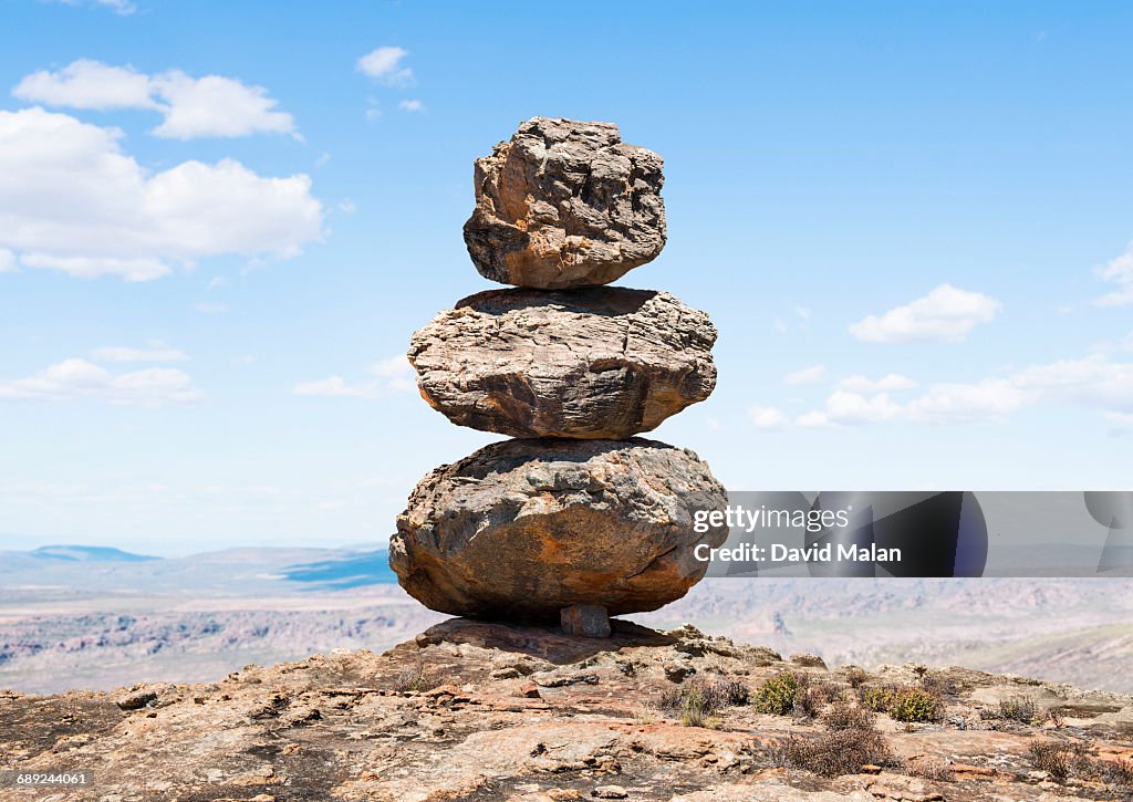 Three big rocks piled on top of each other.
