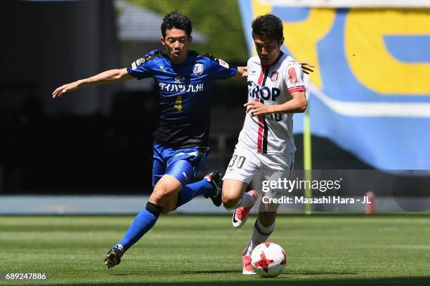 Yuta Toyokawa of Fagiano Okayama and Akira Takeuchi of Oita Trinita compete for the ball during the J.League J2 match between Oita Trinita and...