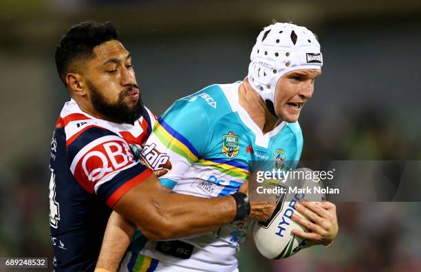 Jarrod Croker of the Raiders is tackled during the round 12 NRL match between the Canberra Raiders and the Sydney Roostrers at GIO Stadium on May 28,...